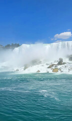 Misty waterfall cascades into azure depths, echoing serene tranquility of International Waterfall Day and global hydrotherapy celebrations
