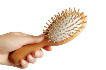 Hand holding a wooden hairbrush.