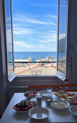 Mediterranean feast whispers through open window, coastal brunch alchemy, Ferragosto serenity, savory indulgence with azure seascape allure
