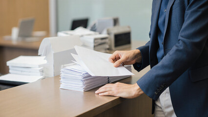 Sorting envelopes at reception desk 