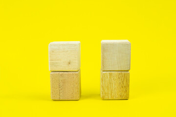Wooden cubes for your text, icons, sign and symbols to create your creative concepts. Mockup blank wooden cubes isolated on yellow background