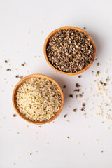 Hemp seeds in wooden bowl on light background. Superfood, natural organic seeds for healthy eating, source of protein, vitamins and omega 3. Healthy food concept