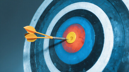 Dart hitting bullseye target 