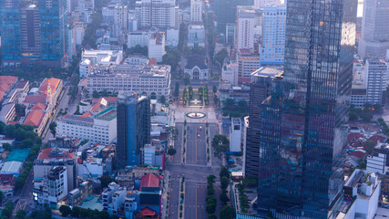 Fototapeta premium Aerial view of early morning in Ho Chi Minh City, Vietnam with development buildings, transportation, energy power infrastructure. Financial and business centers