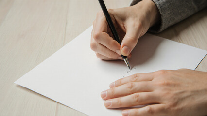 First-person POV of hands writing on paper 