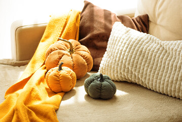 Autumnal living room decor with corduroy pumpkins and cozy pillows.
