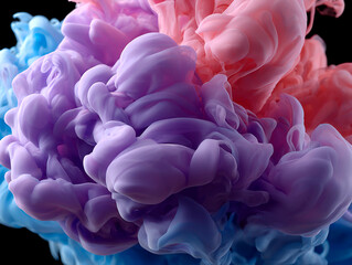 Fototapeta premium Vibrant clouds of purple, pink and blue ink swirling together in water creating soft abstract forms on black background