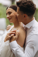 A Romantic Couple Embracing in Nature Amidst Beautiful Scenery and Warm Sunlight