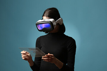 Woman Using VR Headset and Transparent Touch Interface on Blue Background