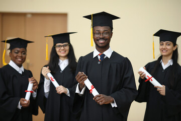 Group, students and diversity at college graduation, happiness for degree or diploma certificate. Team, graduates and celebrating for academic achievement at university campus, smile for knowledge