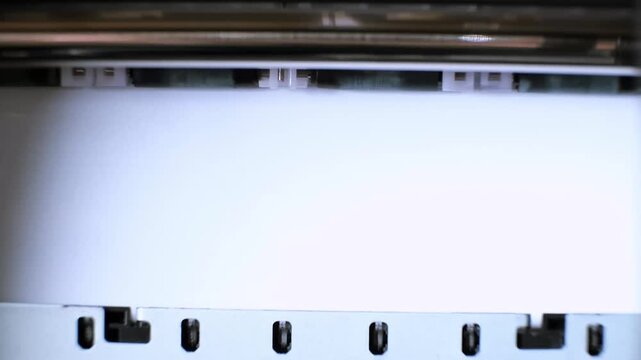 Printing process of color inkjet printer close-up. The rolles is rolling inside of device and printed a picture. A color calibration test. The printing on white paper sheet. High quality 4k footage.