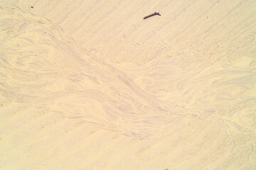 A natural abstract background of wet sand after the tide. Beach patterns.
