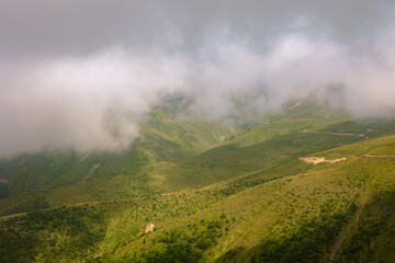 Misty mountains with fog and rural roads