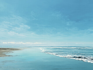 Breathtaking ocean landscape meeting sandy beach under blue sky