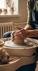 Skilled hands shaping clay on a pottery wheel.