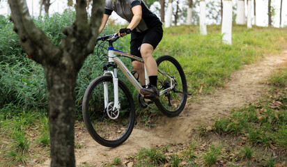 Woman mountain biking on mountain trail