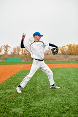 Teenage boy showcases his pitching skills on a vibrant baseball field in autumn