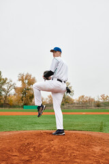 Confident player ready to pitch on a vibrant baseball field in autumn