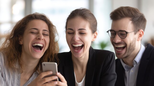 Laughing Young Adults Sharing a Smartphone Moment