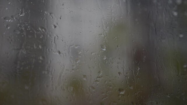 Rainy day in Recoleta, Buenos Aires: gray urban landscape filmed from an apartment. Wet streets, overcast sky, and construction in the rain. Detailed shots with interior references. 