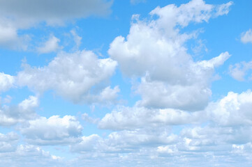 Horizontal bright blue sky with many fluffy white clouds.Nature ,beautiful weather,sky background.