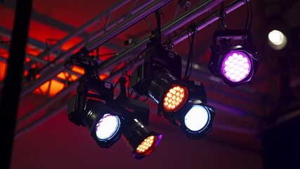 Stage lighting with spotlights being installed on aluminum concert stage	
