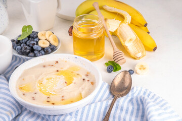Sweet breakfast farina porridge with butter, honey and fruits. American creamy milled wheat flour porridge, hot breakfast cereal