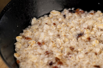 porridge with fruits in a bowl , cooking instant oatmeal porridge, close up