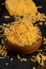 grated hard cheese for cooking, grated cheese for cooking and folded into a wooden bowl