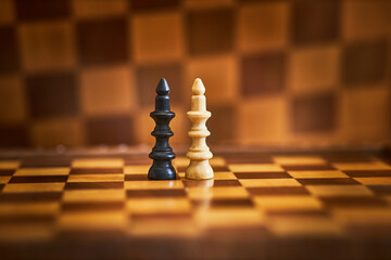 Pieces of chess on a chessboard, natural light, bright wooden material