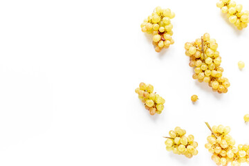 Many bunches of ripe yellow grapes on white background, top view
