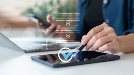 Businesswoman using tablet and smartphone to manage digital logistics workflow with delivery icons and checklists. Concept of smart supply chain, transport tracking, and e-commerce logistics.