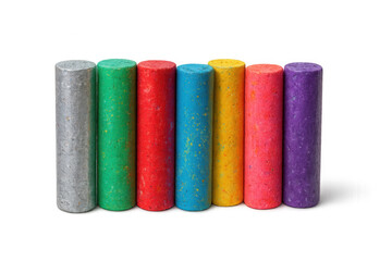 Seven colorful chalk sticks are standing upright on a transparent background, ready for creative drawing and artistic expression