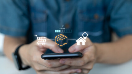 Close-up of hands holding smartphone with icons showing online shopping, package shipping, and home delivery process. Concept of e-commerce logistics and real-time delivery tracking.