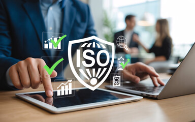 Businessman interacting with ISO certification digital interface with colleagues in background Keywords: ISO, certification, standard, quality