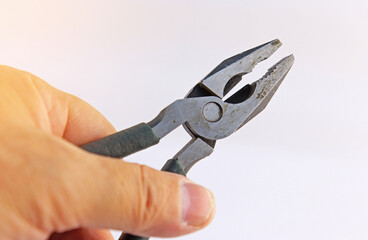 Hand holding electrical tools to assemble the electrical control panel. 