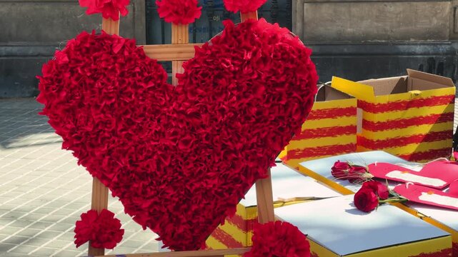 Sant Jordi, holiday of Catalonia patron. Men give a rose to women, women give them a book in exchange. Street stall with roses and books. High quality 4k footage