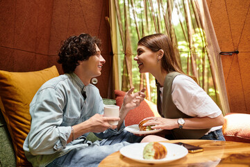 Young couple cherishes a blissful moment together while enjoying lunch in a cozy park setting