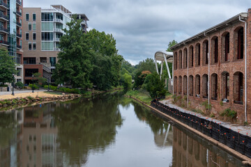 A Reedy River runs through Greenville SC with a brick building on the right