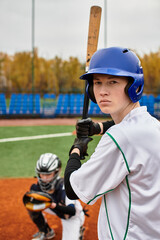 Fototapeta premium Teenage boys play baseball on a lively field on an autumn afternoon