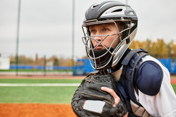 Talented teenage boy ready to catch a pitch on the baseball field during practice