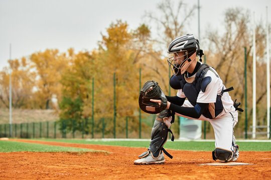 Teenager aiming for success while playing baseball on a bright autumn day in the field