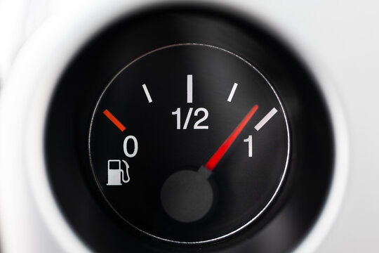 Car fuel gauge with pump pictogram, showing close to full tank. Macro close up shot, no people