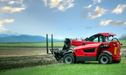 A red tractor with a forklift on the front