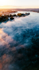 River mist rising from the river as the morning sunshine filters through.