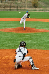 Teenage boys engaged in a thrilling baseball game on a sunny field