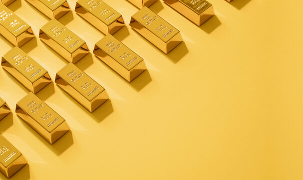 Mockup made of gold bars over yellow background with copy space