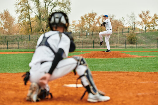 Teenage boys enjoying a spirited baseball game on a vibrant green field
