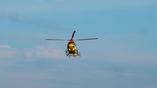 The medical helicopter flies carefully during the journey, arriving at the site of a disaster or emergency in a remote area.