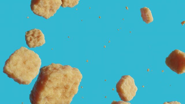 Falling nuggets motion graphics on blue background. 3d loops animation